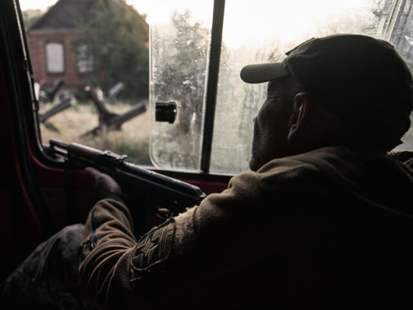 KOSTIANTYNIVKA FRONTLINE, UKRAINE - JUNE 17: A soldier holds a machine gun and prepares to
