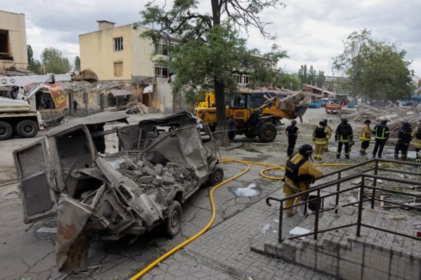 Rescuers and police at a damaged residential building following a Russian strike on Kramat