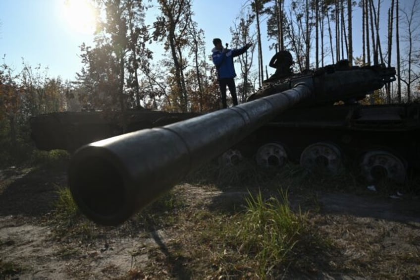 Spanish traveller Alberto Blasco Ventas visits a tank graveyard during a tour near Dmytriv