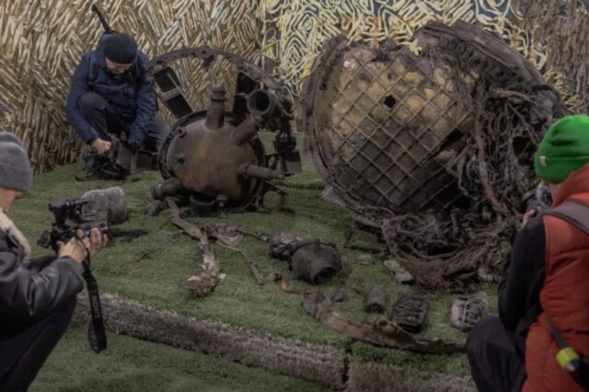 Reporters photograph parts from an 'experimental' Russian missile at Ukrainian forsenics c