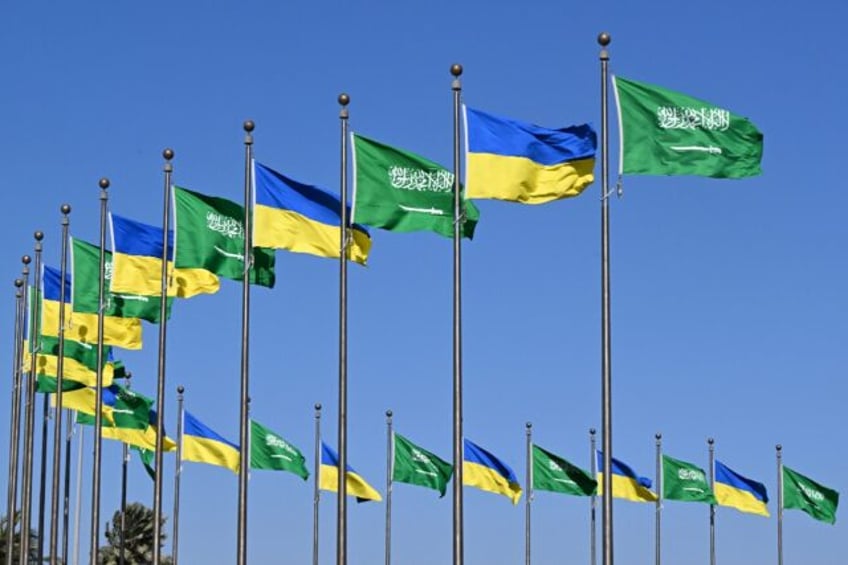 Flags of Saudi Arabia and Ukraine line a road in Jeddah before a visit by Ukainian Preside