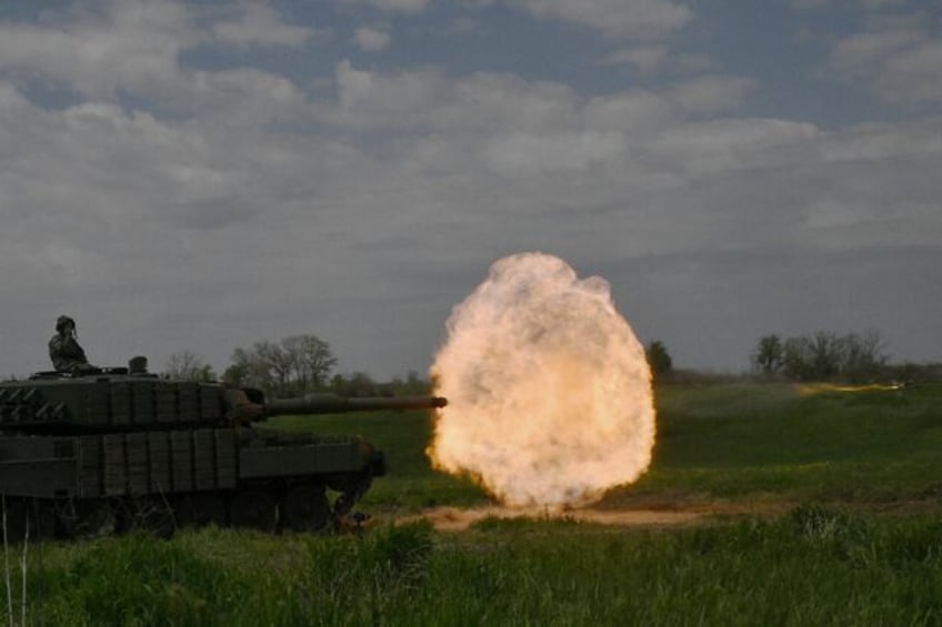 A tank crew of the Ukrainian 33rd Separate Mechanized Brigade fire a round from a Leopard