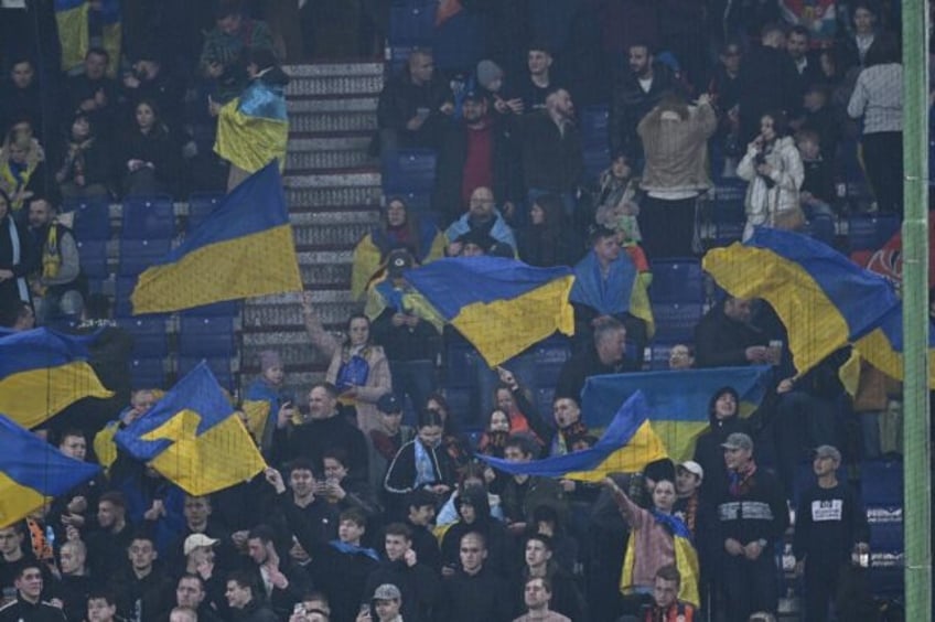 Shakhtar Donetsk fans wave Ukraine flags at a match with Marseille in Hamburg