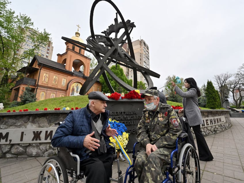 Disabled liquidators of Chernobyl nuclear power plant catastrophe, talk during the commemoration of the victims of the Chernobyl nuclear disaster on the 38th anniversary of the world's worst nuclear accident, at the Chernobyl memorial in Kyiv on April 26, 2024. (Photo by Sergei SUPINSKY / AFP)