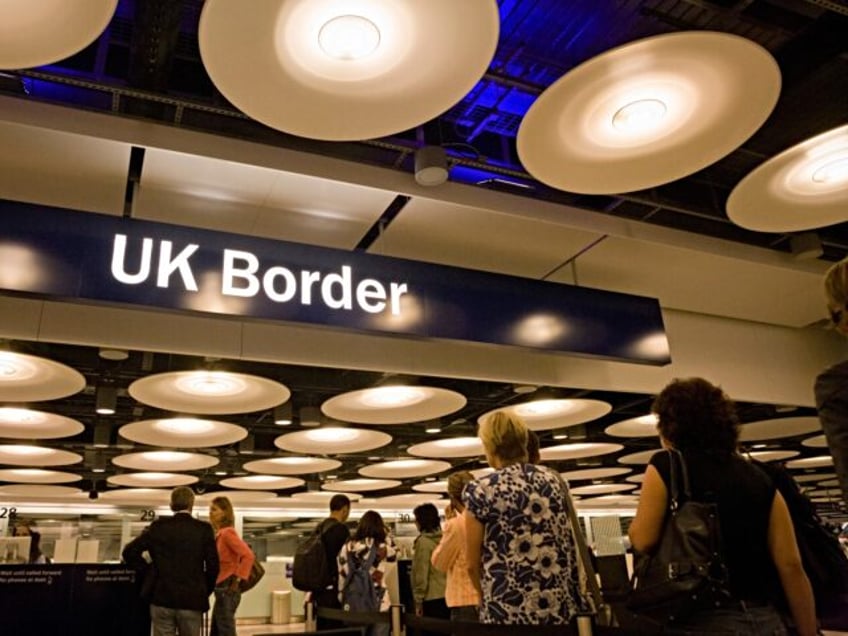 Queues of newly-arrived airline passengers line up to await their turn at the UK Border Agency's passport control, 12th August 2008, Heathrow Airport, London, England. Immigration officers deal with each member of the public seeking entry into the United Kingdom but on average, 10 a day are refused entry at …