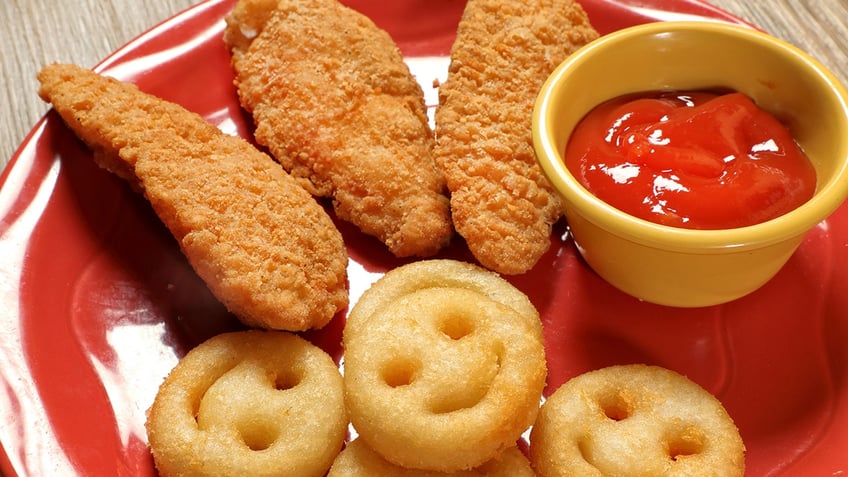 french fries and chicken fingers with ketchup