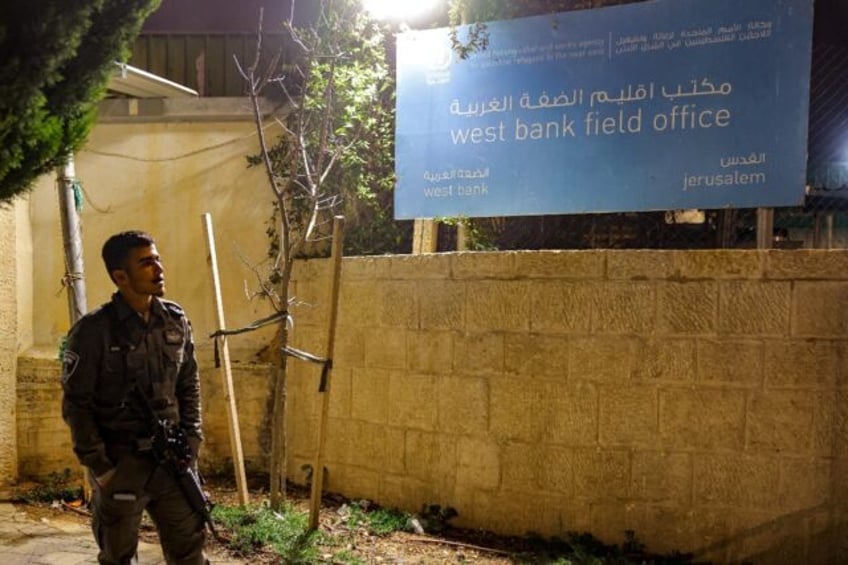 An Israeli border guard stands by during a protest by Israeli right-wing activists (not in frame) outside the West Bank field office of the United Nations Relief and Works Agency for Palestine Refugees (UNRWA) in Jerusalem