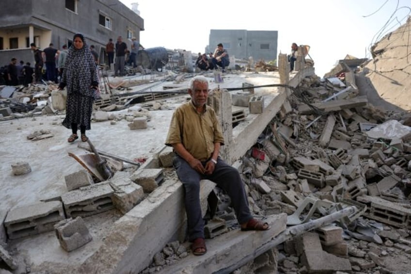 People check the destruction following an Israeli strike that hit the home of a Palestinia