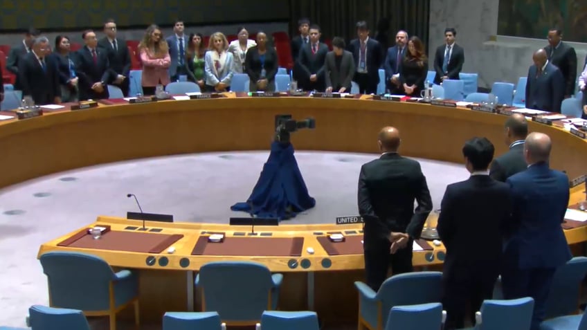 Members of U.N. Security Council standing to honor Raisi