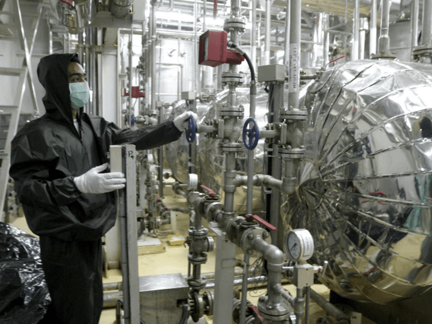 An Iranian technician works at a Uranium Conversion Facility (UCF) in Isfahan 20 November 2004. Representatives and ambassadors from Cuba, Algeria, South Africa and Malaysia along with IAEA`s inspectors visited the Isfahan facility and became acquainted with uranium processing in the center. AFP PHOTO/STR (Photo credit should read -/AFP/Getty Images)