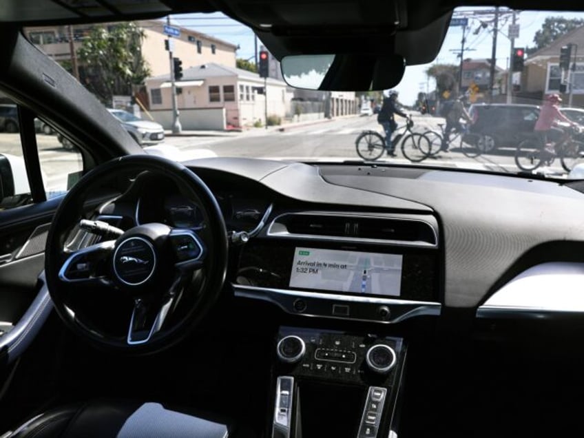 LOS ANGELES, CALIFORNIA - MARCH 14: A Waymo autonomous self-driving Jaguar taxi drives alo