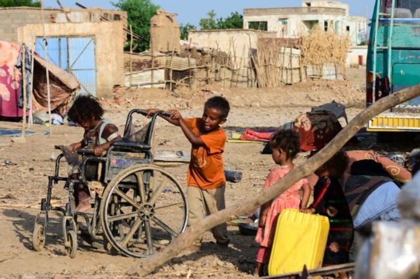 Sudanese children play on a street in Tokar, in Red Sea State, following heavy flooding in
