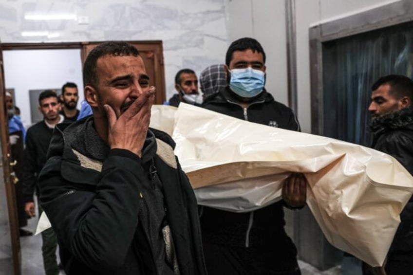 Mourners move the body of Palestinian, killed during an Israeli strike, from the EU hospital in Khan Yunis, southern Gaza