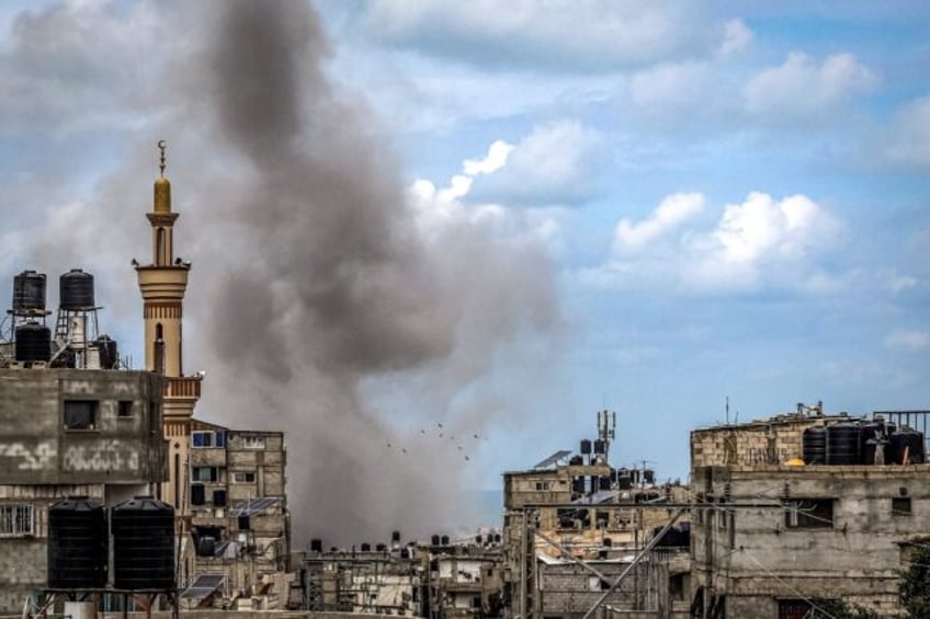 A smoke plume erupts during Israeli bombardment in Rafah, the southern Gaza Strip, where w