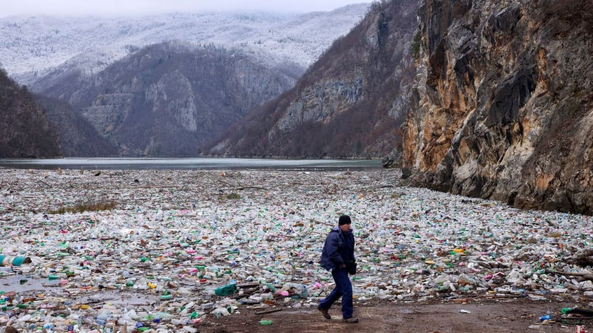  crane operator walks next to the waste footing in the Drina river near Visegrad, Bosnia