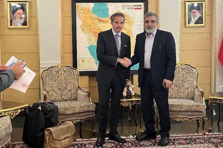 An Iranian Atomic Energy Organization picture shows IAEA chief Rafael Grossi (L) with IAEO