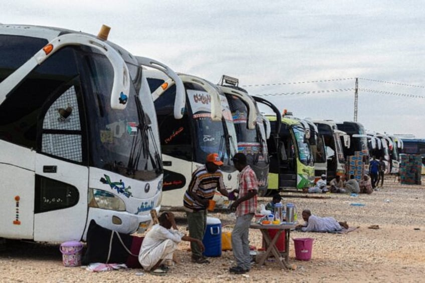 Sudanese drivers rest on May 14, 2023 after transporting evacuees from Sudan into Egypt, i