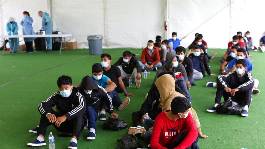 Unaccompanied migrant children on the floor in facility