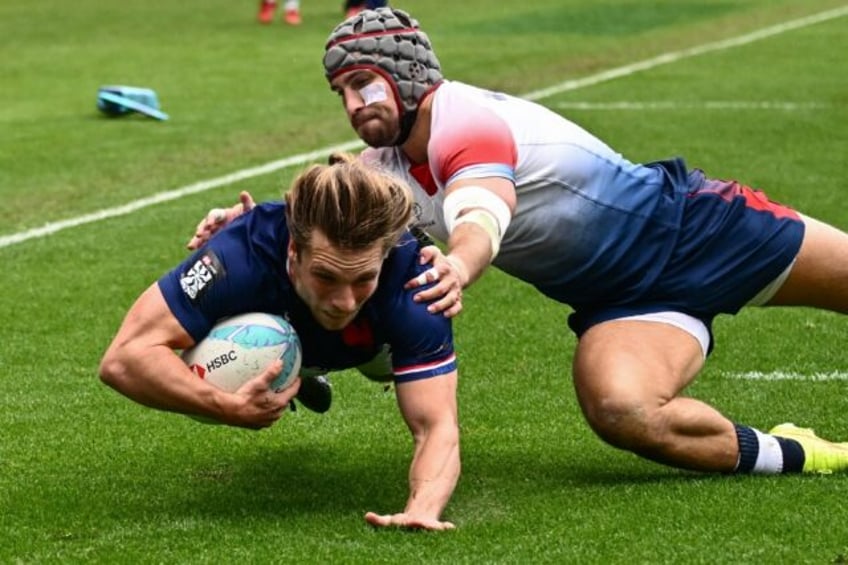 France's Stephen Parez-Edo Martin dives past Great Britain's Ethan Waddleton to score a tr