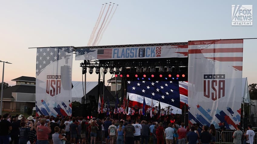 Wide shot of the state with a patriotic flyover in the background