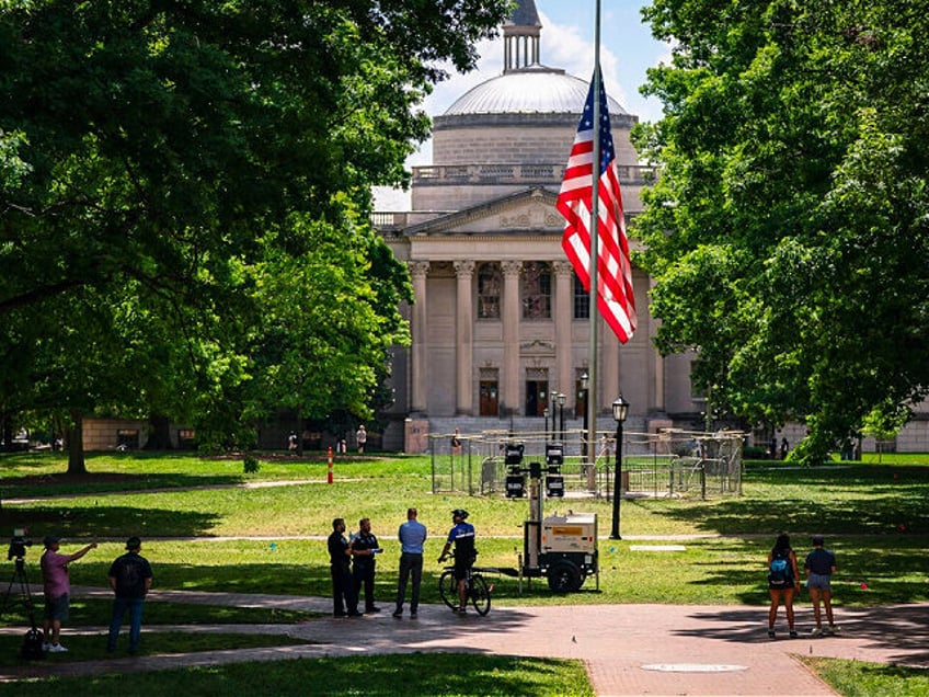 CHAPEL HILL, NORTH CAROLINA - MAY 1: A barricade protects the American flag at Polk Place