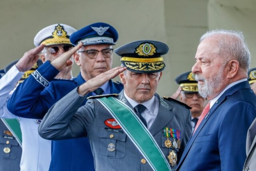 Brazil's President Luiz Inacio Lula da Silva (R) receiving salutes from the Armed Forces C