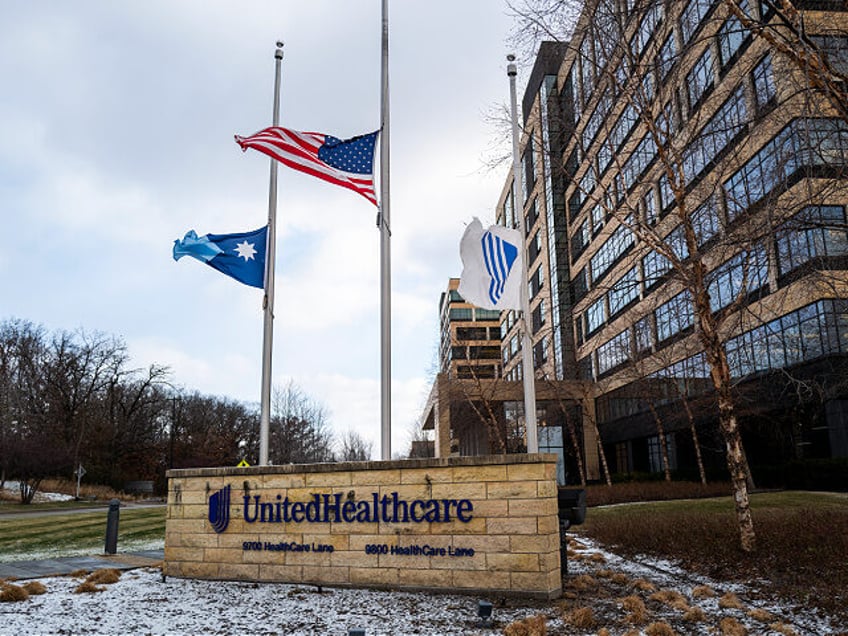 MINNETONKA, MINNESOTA - DECEMBER 4: Flags fly at half mast outside the United Healthcare c