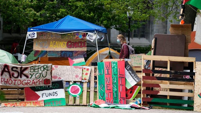 A student walks in the anti-Israel encampment on the Main Quad at the University of Chicago. 