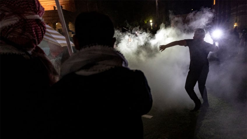 Counter protesters attack a pro-Palestinian encampment at UCLA.