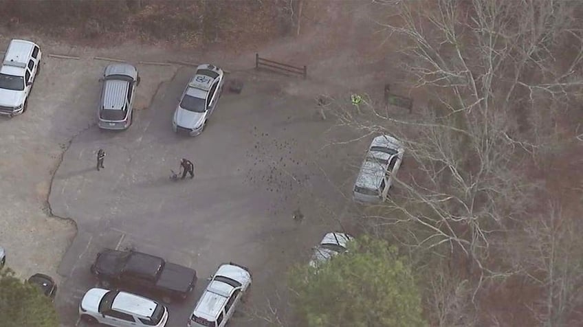 An aerial view of a wooded area behind Lake Herrick