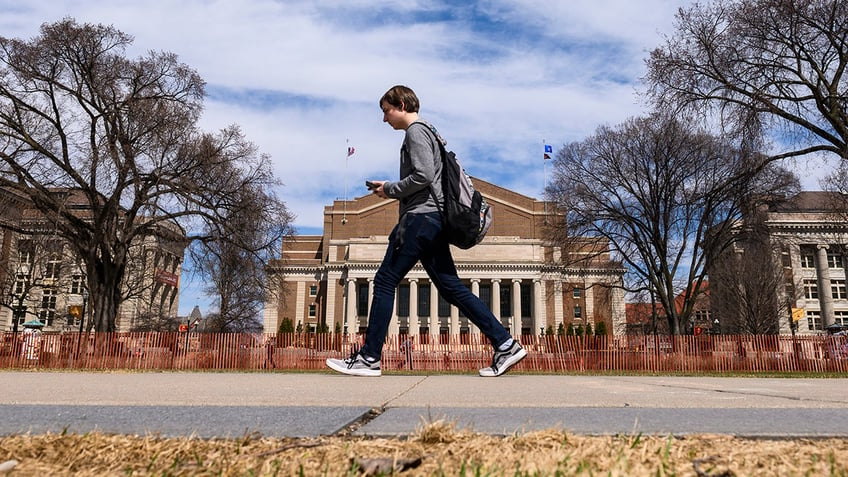 A pedestrian walks at the University of Minnesota campus