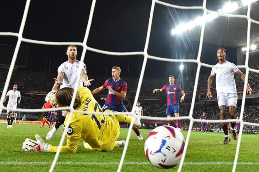 unlucky sergio ramos own goal helps barca beat sevilla