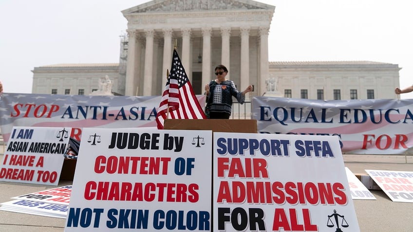 Supreme Court protester with posters