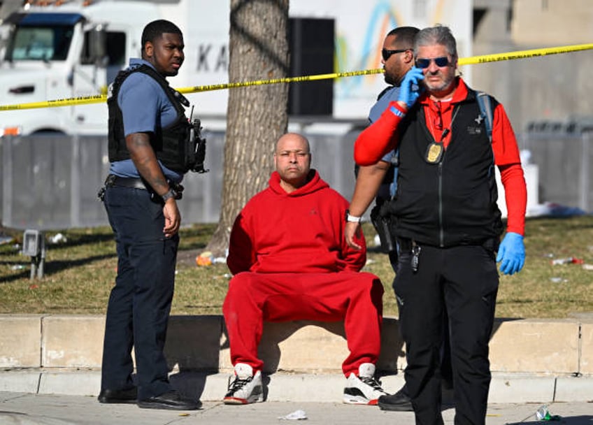 Person is detained by police near the Kansas City Chiefs' Super Bowl LVIII victory parade on February 14 in Kansas City, Missouri. Shots were...