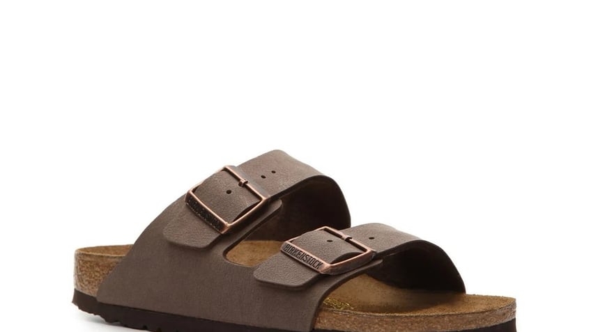 The classic Birkenstock Arizona sandal features leather straps and a contoured cork footbed that conforms to the shape of your foot.
