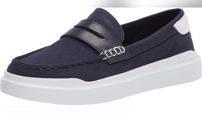 These women’s Cole Haan loafers combine classic style with modern comfort, featuring a lightweight EVA outsole and cushioned footbed in breathable canvas.