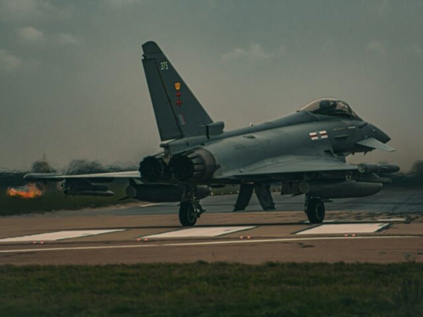 a fighter jet sitting on top of an airport runway RAF Eurofighter Typhoon RAF Coningsby