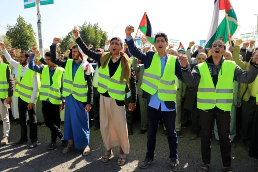 Yemenis wave Palestinian flags as they chant anti-Israel and anti-US slogans during a protest in solidarity with the Palestinian people in the Huthi-controlled capital Sanaa