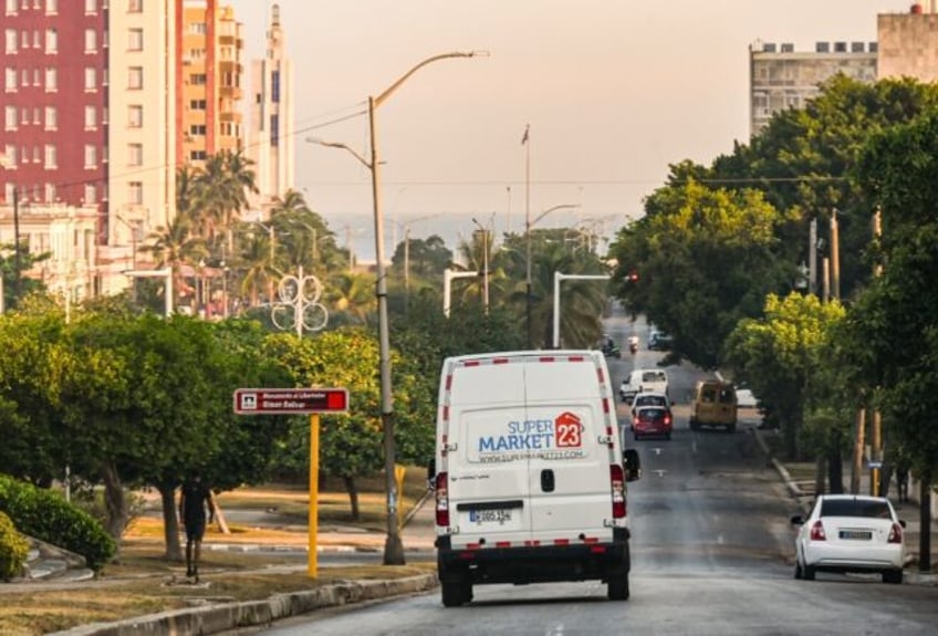 A delivery van from a US-based food remittance company drives on a street in Havana on May