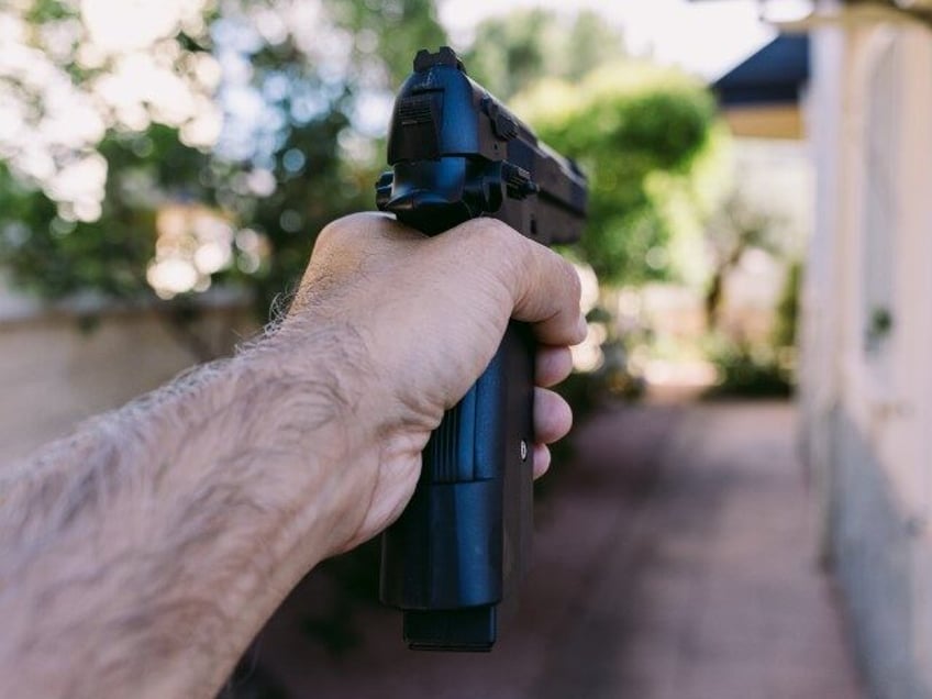 gun-Hand and arm of man pointing gun