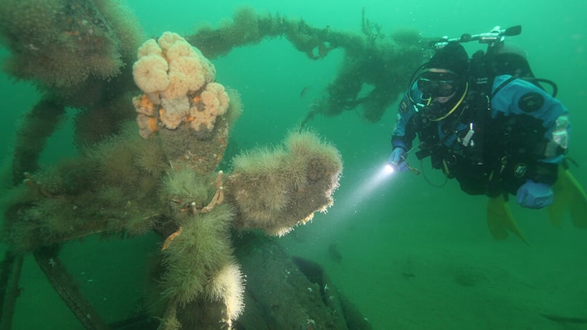 A diver inspects the North Star's propeller