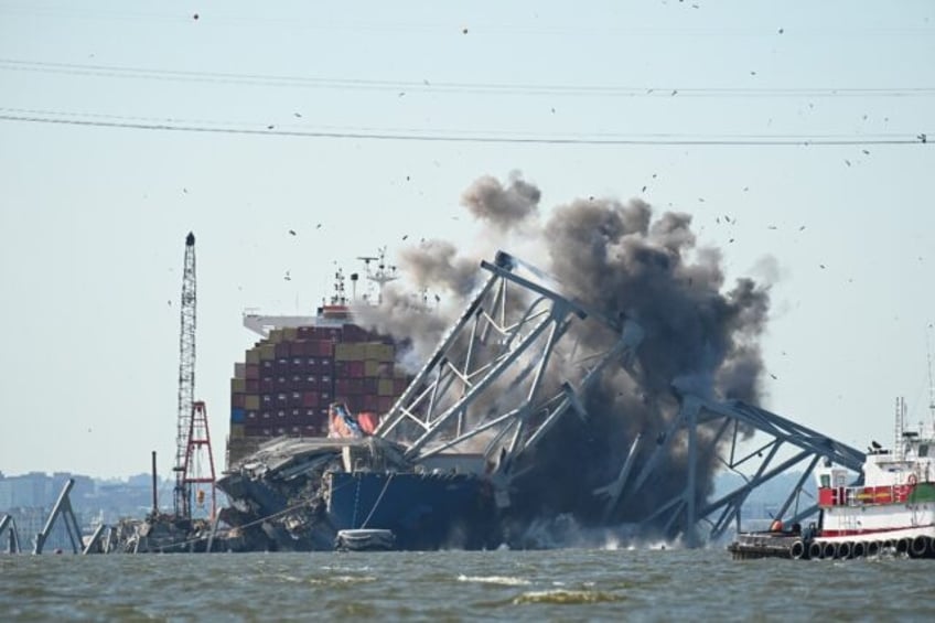 Crews conduct a controlled demolition of a section of the Francis Scott Key Bridge resting