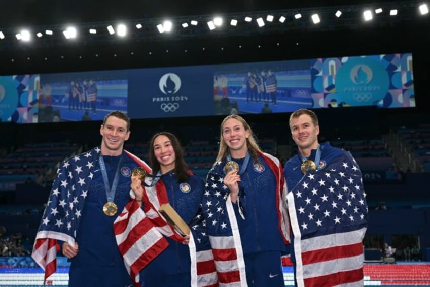 The USA's Ryan Murphy, Torri Huske, Gretchen Walsh and Nic Fink after winning the mixed 4x