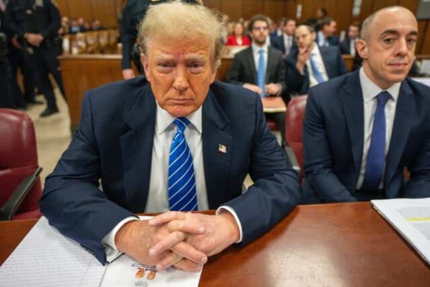 Former US President Donald Trump looks on during his criminal trial for allegedly covering