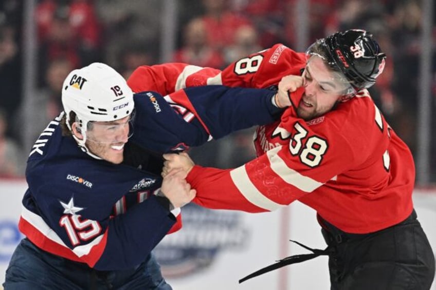 Team USA's Matthew Tkachuk, left, fights Canada's Brandon Hagel early in the first period