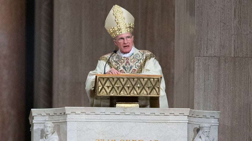 Catholic Archbishop preaching at the podium.
