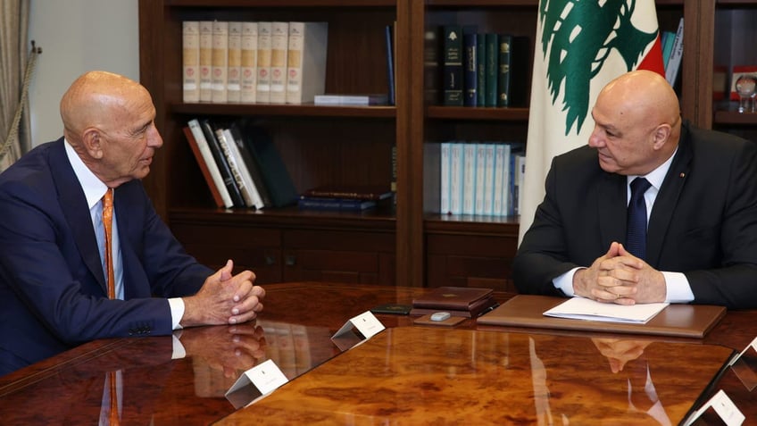 Tom Barrack and Lebanese President Joseph Aoun at a table speaking to one another