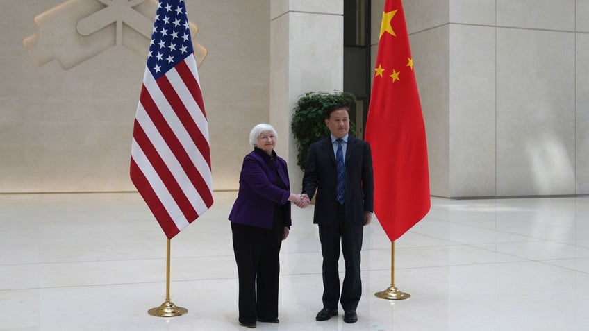 U.S. Treasury Secretary Janet Yellen shakes hands with Governor of the People's Bank of China Pan Gongsheng