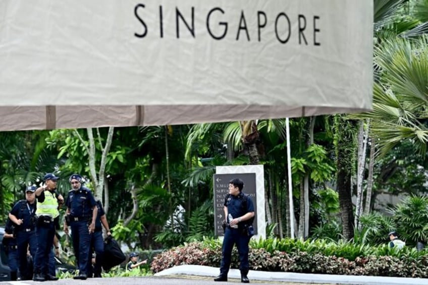 Police officers stand watch outside Singapore's Shangri-La Hotel on Friday, site of a year