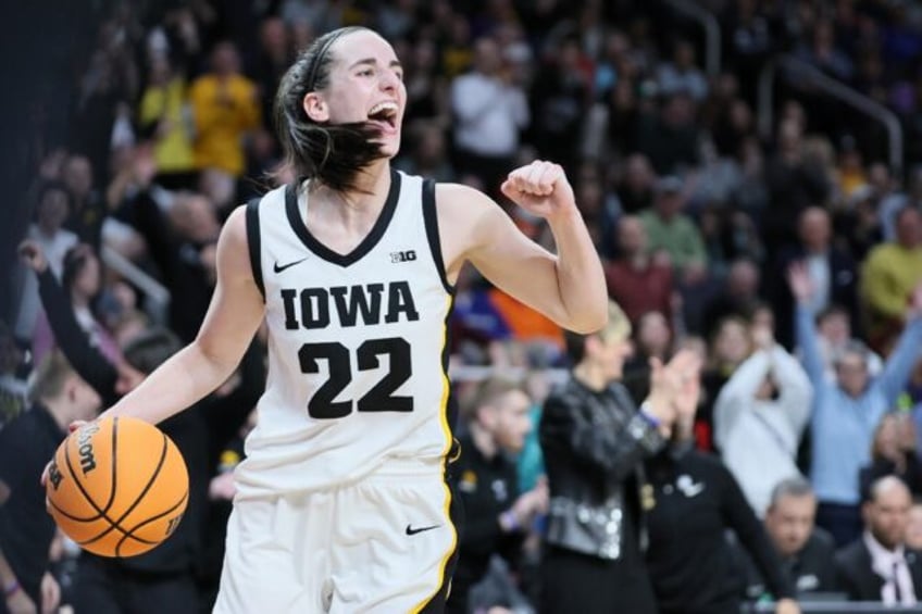 Caitlin Clark celebrates leading the Iowa Hawkeyes back to the final four of US college ba